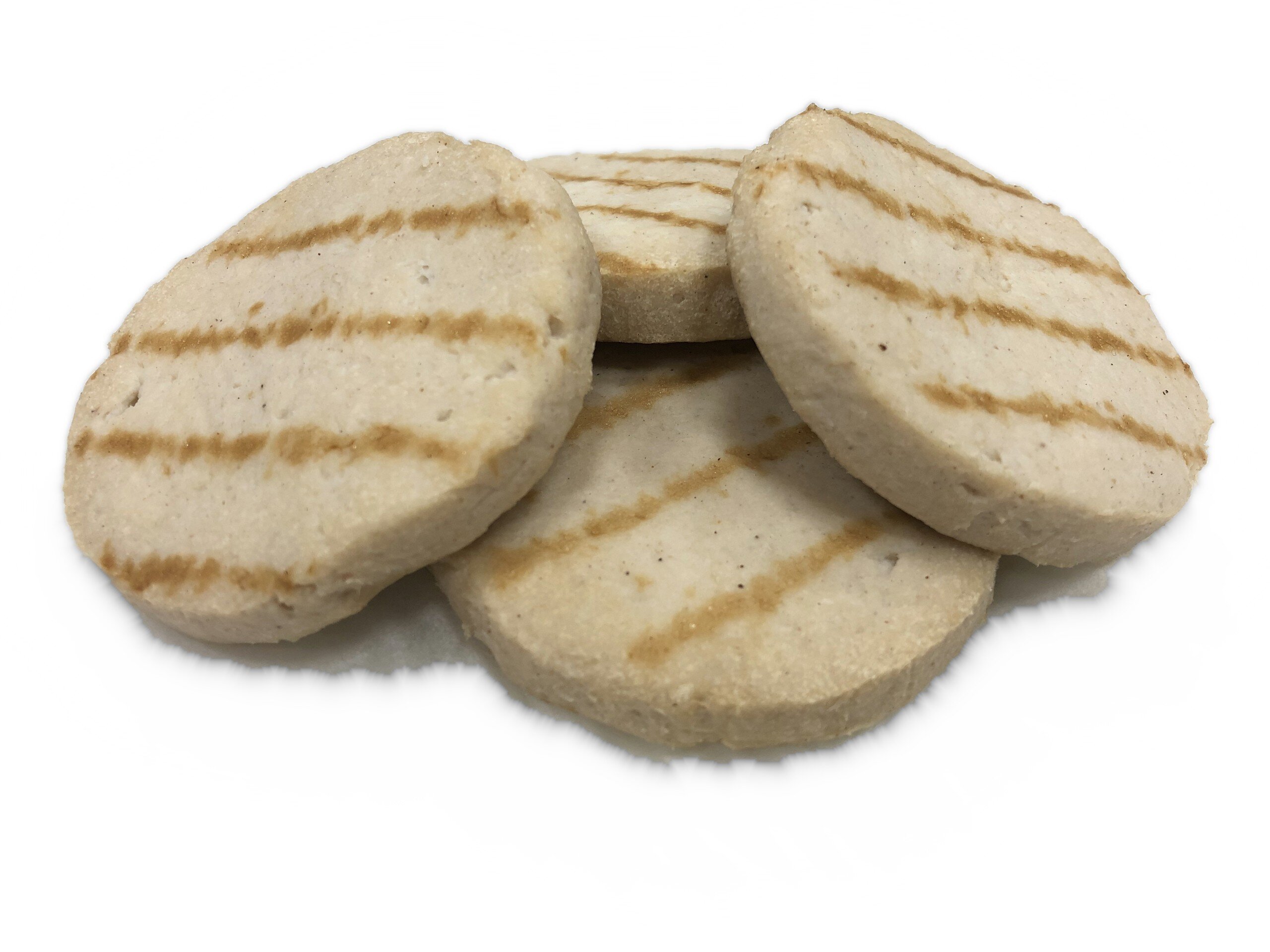Four light round slices with brown grill stripes deposited on top