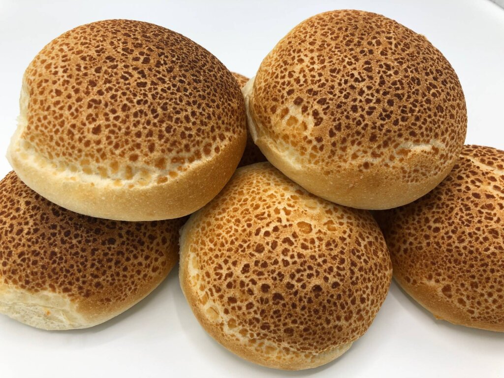 Close-up of a stack of tiger rolls with a crackled, spotted crust